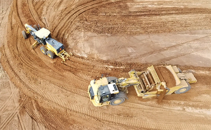 Grader and scraper earthwork machines at work.