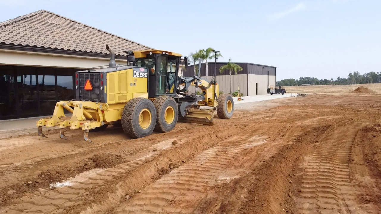 Image of a grading machine in a residential backyard.