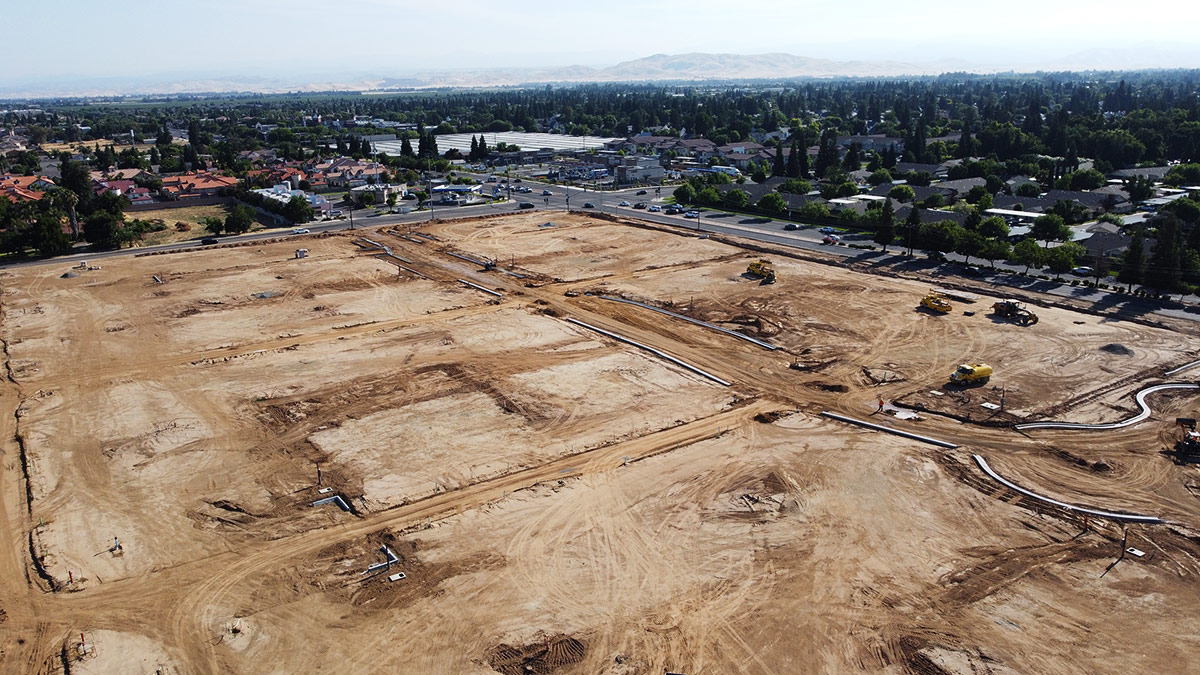 Image captured by a drone, showcasing an earthwork project on the cross streets of Alluvial and Willow in Clovis, CA.